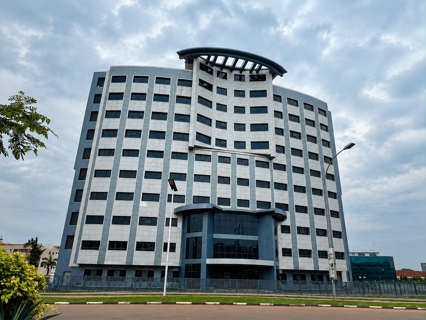 The Nisa International Medical Center building in Wuse 2, Abuja — a modern white tower with a curved blue glass façade
