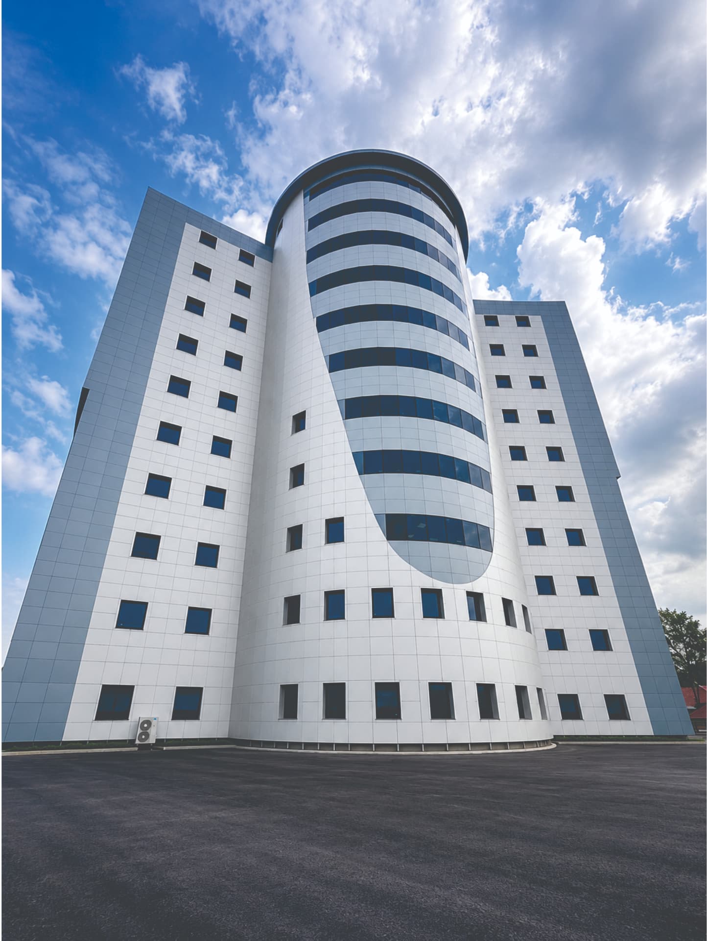 The Nisa International Medical Centre tower in Wuse 2, Abuja — a white façade with a curved blue glass core